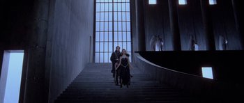 Movie still from “Opera” (1987), directed by Dario Argento – Two women are walking down a set of stairs; Wide shot, Low angle