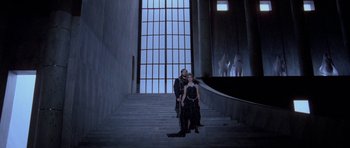 Movie still from “Opera” (1987), directed by Dario Argento – A man and a woman posing for a picture on the stairs; Wide shot, Low angle