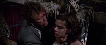 Movie still from “Opera” (1987), directed by Dario Argento – A man and a woman are in a room with ropes; Close Up shot, High angle