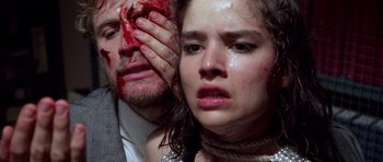 Movie still from “Opera” (1987), directed by Dario Argento – A man and a woman with blood all over their faces; Extreme Close Up shot, Overhead angle