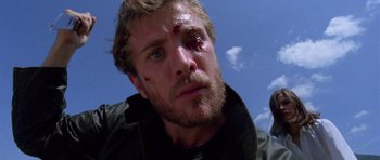 Movie still from “Opera” (1987), directed by Dario Argento – A person with a wound on his face; Close Up shot, Low angle