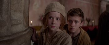 Movie still from “Ophelia” (2018), directed by Claire McCarthy – A girl and a boy are holding a candle in their hands; Close Up shot, Over the shoulder angle