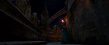 Movie still from “Ophelia” (2018), directed by Claire McCarthy – A woman in a long dress is holding a candle; Extreme Wide shot, Low angle