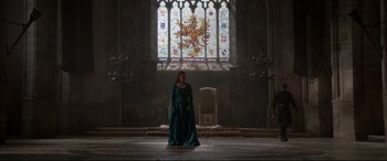 Movie still from “Ophelia” (2018), directed by Claire McCarthy – A woman standing in front of a stained - glass window; Extreme Wide shot, Low angle