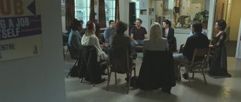 Movie still from “Oranges and Sunshine” (2010), directed by Jim Loach – A group of people sitting in a circle in a room; Wide shot, High angle