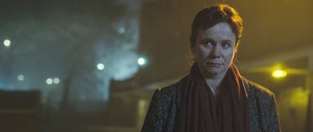 Movie still from “Oranges and Sunshine” (2010), directed by Jim Loach – A woman in a black jacket and a red scarf; Close Up shot, Low angle