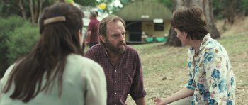 Movie still from “Oranges and Sunshine” (2010), directed by Jim Loach – A man with a goatee talking to two women; Medium shot, Over the shoulder angle