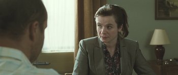 Movie still from “Oranges and Sunshine” (2010), directed by Jim Loach – A woman sitting in a chair in front of a window; Close Up shot, Over the shoulder angle