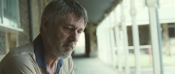 Movie still from “Oranges and Sunshine” (2010), directed by Jim Loach – An older man wearing a blue neck tie looking at the camera; Close Up shot, Low angle