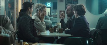 Movie still from “Oranges and Sunshine” (2010), directed by Jim Loach – A group of people sitting at a table in a restaurant; Medium shot, Over the shoulder angle