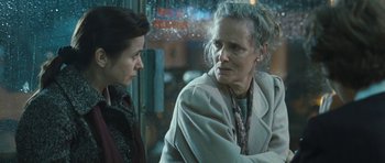 Movie still from “Oranges and Sunshine” (2010), directed by Jim Loach – Two women sitting next to each other in front of a store window; Close Up shot, Over the shoulder angle