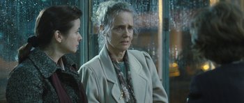 Movie still from “Oranges and Sunshine” (2010), directed by Jim Loach – An older woman is looking at the camera while standing next to a younger woman; Close Up shot, Over the shoulder angle