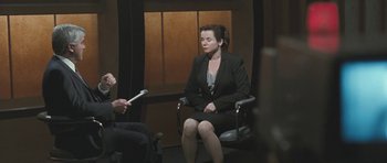 Movie still from “Oranges and Sunshine” (2010), directed by Jim Loach – A woman sitting in a chair in front of a man; Medium shot, Over the shoulder angle