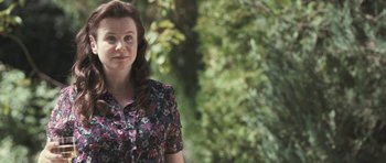 Movie still from “Oranges and Sunshine” (2010), directed by Jim Loach – A woman standing in front of a tree; Medium shot, Over the shoulder angle