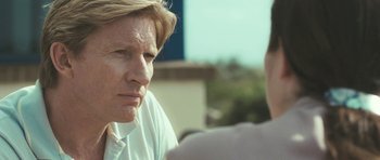 Movie still from “Oranges and Sunshine” (2010), directed by Jim Loach – A man sitting next to another man in a white shirt; Close Up shot, Over the shoulder angle