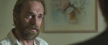 Movie still from “Oranges and Sunshine” (2010), directed by Jim Loach – A person with a beard; Close Up shot, Over the shoulder angle