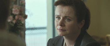 Movie still from “Oranges and Sunshine” (2010), directed by Jim Loach – A person wearing a suit and tie; Close Up shot, Over the shoulder angle