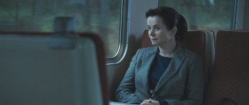Movie still from “Oranges and Sunshine” (2010), directed by Jim Loach – A woman sitting on a train looking out the window; Medium shot, Over the shoulder angle