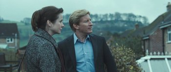 Movie still from “Oranges and Sunshine” (2010), directed by Jim Loach – A man and a woman standing next to each other on top of a hill; Medium shot, Over the shoulder angle