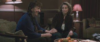 Movie still from “Oranges and Sunshine” (2010), directed by Jim Loach – Two women sitting next to each other on a couch; Medium shot, Over the shoulder angle