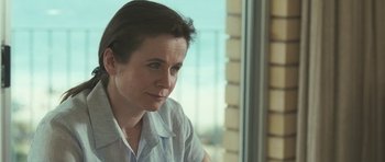 Movie still from “Oranges and Sunshine” (2010), directed by Jim Loach – A woman sitting in front of a window; Close Up shot, Over the shoulder angle