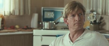 Movie still from “Oranges and Sunshine” (2010), directed by Jim Loach – A person sitting in a kitchen; Close Up shot, Over the shoulder angle