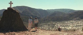 Movie still from “Oranges and Sunshine” (2010), directed by Jim Loach – Two people standing on a hill looking out over a valley; Extreme Wide shot, High angle