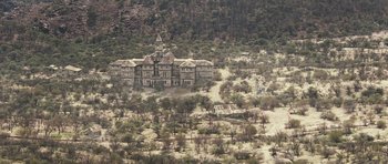 Movie still from “Oranges and Sunshine” (2010), directed by Jim Loach – An old building in the middle of the desert; Extreme Wide shot, High angle