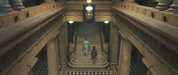 Movie still from “Oranges and Sunshine” (2010), directed by Jim Loach – A man and a woman walking up a set of stairs; Extreme Wide shot, High angle
