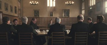 Movie still from “Oranges and Sunshine” (2010), directed by Jim Loach – A group of people sitting at a table in a room; Wide shot, High angle