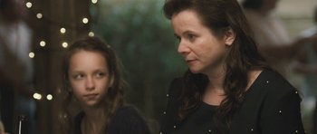Movie still from “Oranges and Sunshine” (2010), directed by Jim Loach – A woman standing next to a girl in a black dress; Close Up shot, Over the shoulder angle
