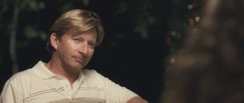 Movie still from “Oranges and Sunshine” (2010), directed by Jim Loach – A person sitting in front of a tree; Close Up shot, Over the shoulder angle
