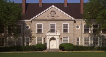 Movie still from “Ordinary People” (1980), directed by Robert Redford – A large brick building with an entrance to the front door; Extreme Wide shot, Low angle