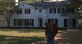 Movie still from “Ordinary People” (1980), directed by Robert Redford – A man standing in front of a white house; Wide shot, Low angle