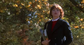 Movie still from “Ordinary People” (1980), directed by Robert Redford – A woman in a black jacket holding a knife and fork; Medium shot, Low angle