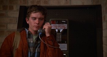 Movie still from “Ordinary People” (1980), directed by Robert Redford – A young man holding a payphone up to his ear; Close Up shot, Over the shoulder angle