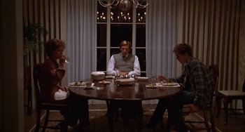 Movie still from “Ordinary People” (1980), directed by Robert Redford – A group of people sitting around a table eating food; Wide shot, High angle