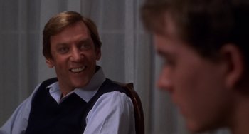 Movie still from “Ordinary People” (1980), directed by Robert Redford – A man sitting in front of another man in front of a window; Close Up shot, Over the shoulder angle