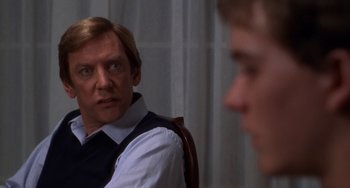 Movie still from “Ordinary People” (1980), directed by Robert Redford – A man sitting in front of another man in front of a window; Close Up shot, Over the shoulder angle