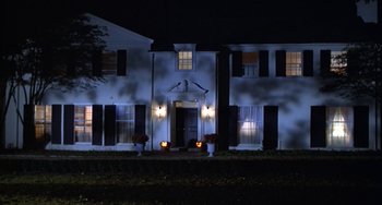 Movie still from “Ordinary People” (1980), directed by Robert Redford – A house that is lit up at night time; Wide shot, Low angle