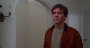 Movie still from “Ordinary People” (1980), directed by Robert Redford – A young man standing in front of an arched doorway; Close Up shot, Over the shoulder angle