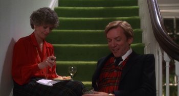 Movie still from “Ordinary People” (1980), directed by Robert Redford – A man sitting on the ground next to a woman; Medium shot, High angle