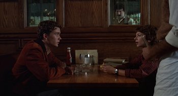 Movie still from “Ordinary People” (1980), directed by Robert Redford – Two men sitting at a table in front of each other; Medium shot, Over the shoulder angle