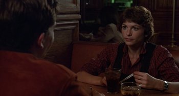 Movie still from “Ordinary People” (1980), directed by Robert Redford – A woman sitting at a table in a restaurant; Close Up shot, Over the shoulder angle