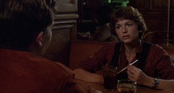 Movie still from “Ordinary People” (1980), directed by Robert Redford – A woman sitting at a table in a restaurant; Close Up shot, Over the shoulder angle