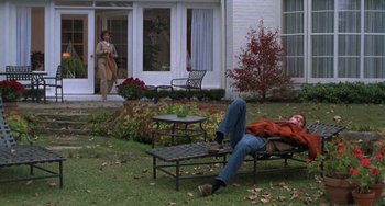 Movie still from “Ordinary People” (1980), directed by Robert Redford – A man laying on top of a lawn chair; Wide shot, High angle