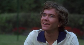 Movie still from “Ordinary People” (1980), directed by Robert Redford – A young man is smiling while sitting in a park; Close Up shot, Low angle