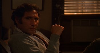 Movie still from “Ordinary People” (1980), directed by Robert Redford – A person sitting in a chair smoking a cigarette; Close Up shot, Low angle