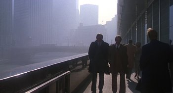 Movie still from “Ordinary People” (1980), directed by Robert Redford – Two men are walking down a sidewalk in a city; Wide shot, Low angle