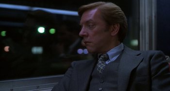 Movie still from “Ordinary People” (1980), directed by Robert Redford – A person wearing a suit and tie; Medium shot, Over the shoulder angle